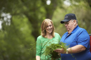 Alpha Fern's Joe and Jennifer Strickland Looking at Ferns Outside