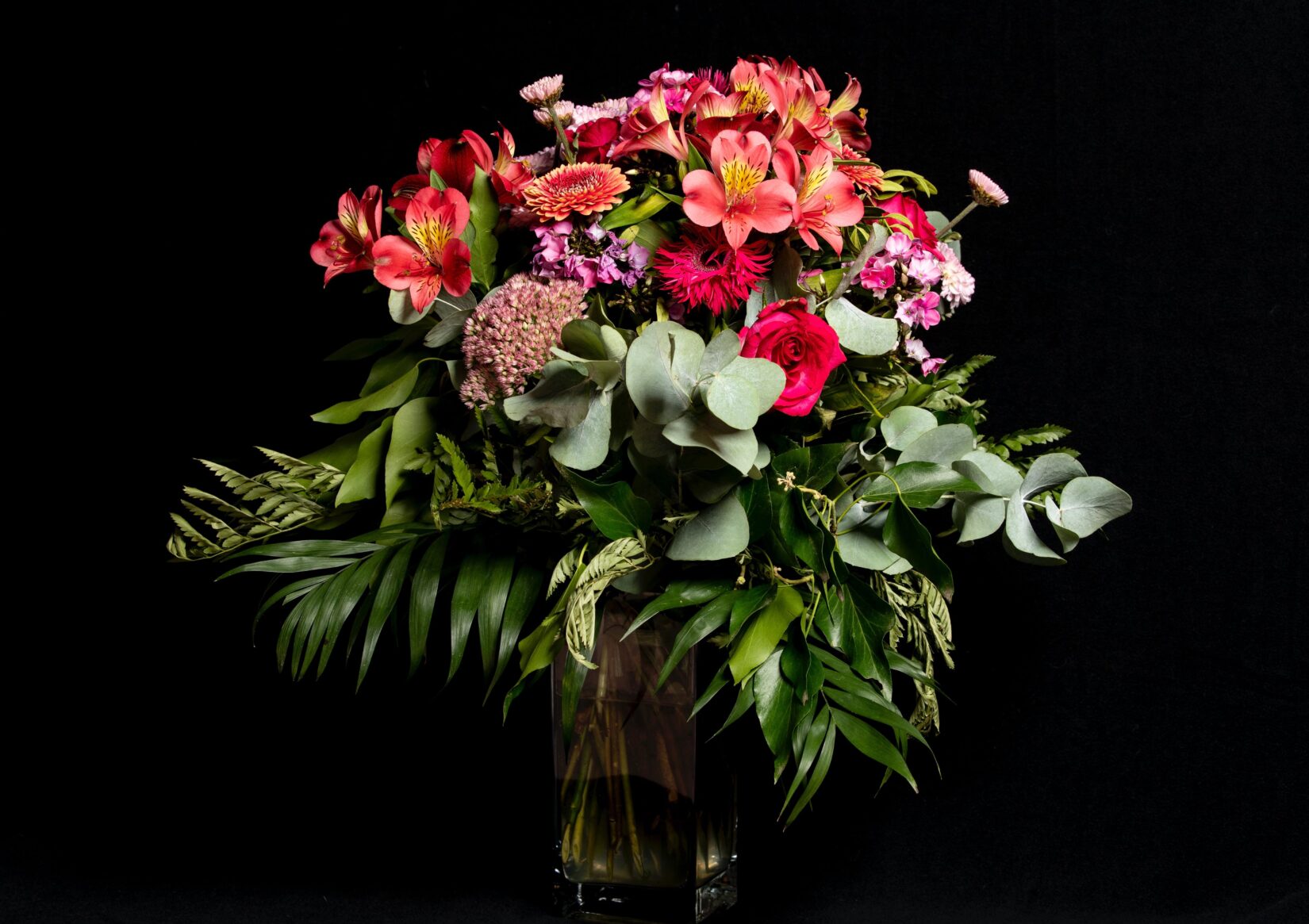 Floral arrangement with eucalyptus and other greenery
