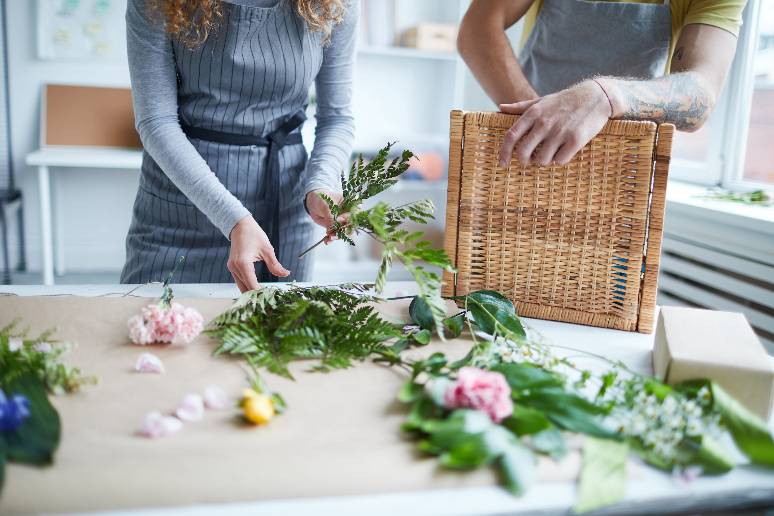 Florists adding ferns to a bouquet