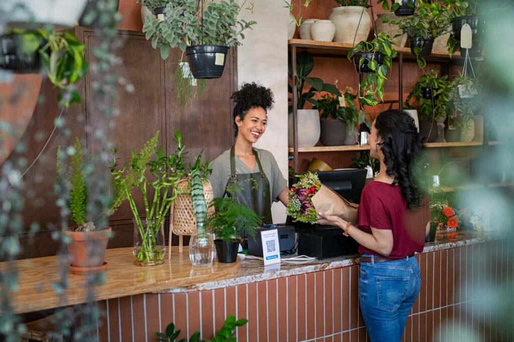 A customer at a florist picking up her bouquet order.