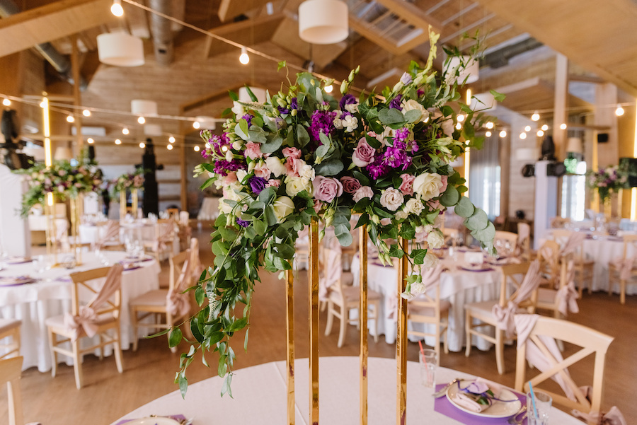 A wedding floral centerpiece with trailing greenery.
