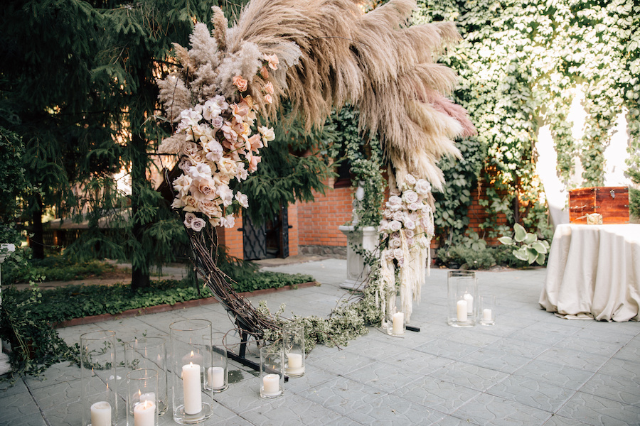 A floral arch featuring pampas grass.