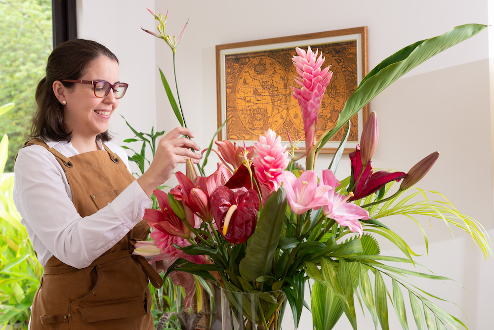 Photo of a florist creating a tropical floral arrangement for summer