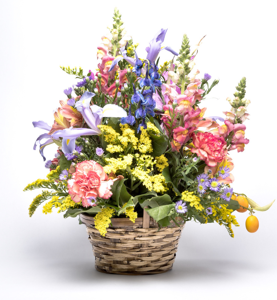 A bouquet displayed using a woven basket as a container.