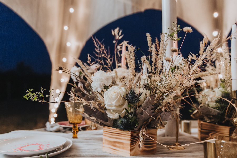 A boho floral arrangement in a wooden box.