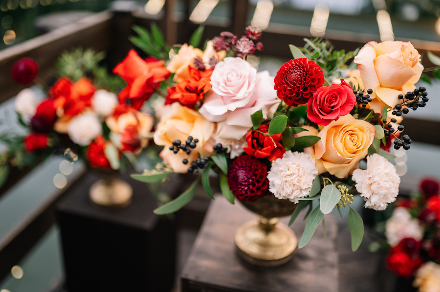 A floral centerpiece with small black berries