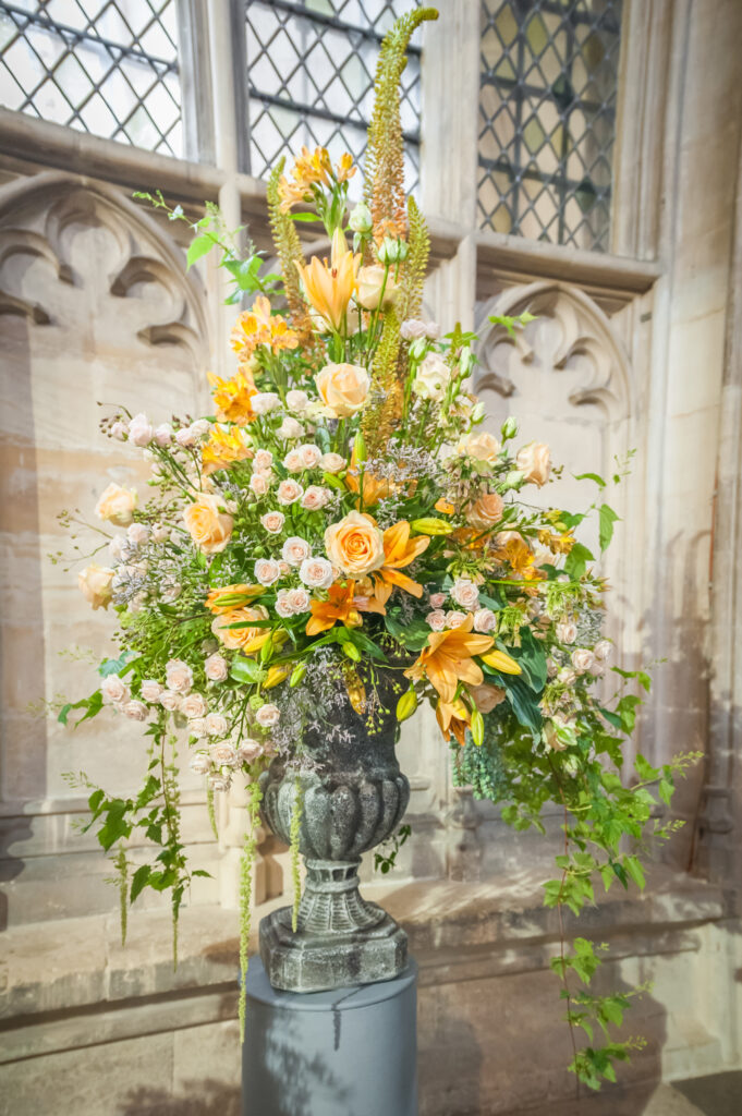A tall floral arrangement with layered foliage.